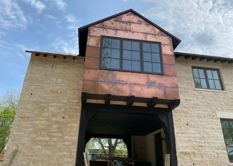 Copper metal panel facade on a stone building for Metal Roof Coating in Lake Barrington